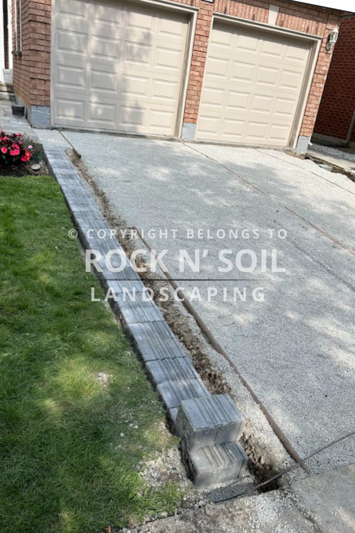 Driveway before interlocking, showing the original state before landscaping work