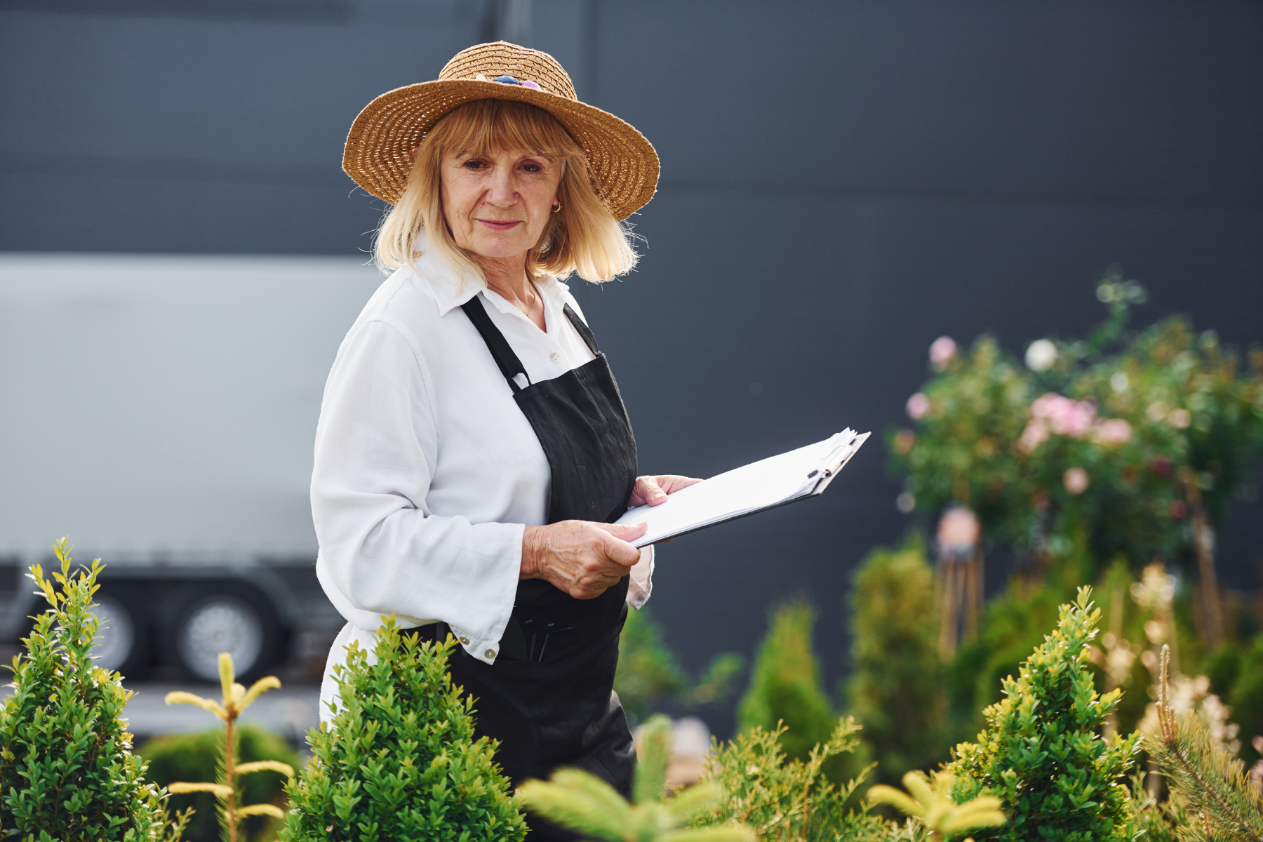 Older woman planning her garden layout in late autumn