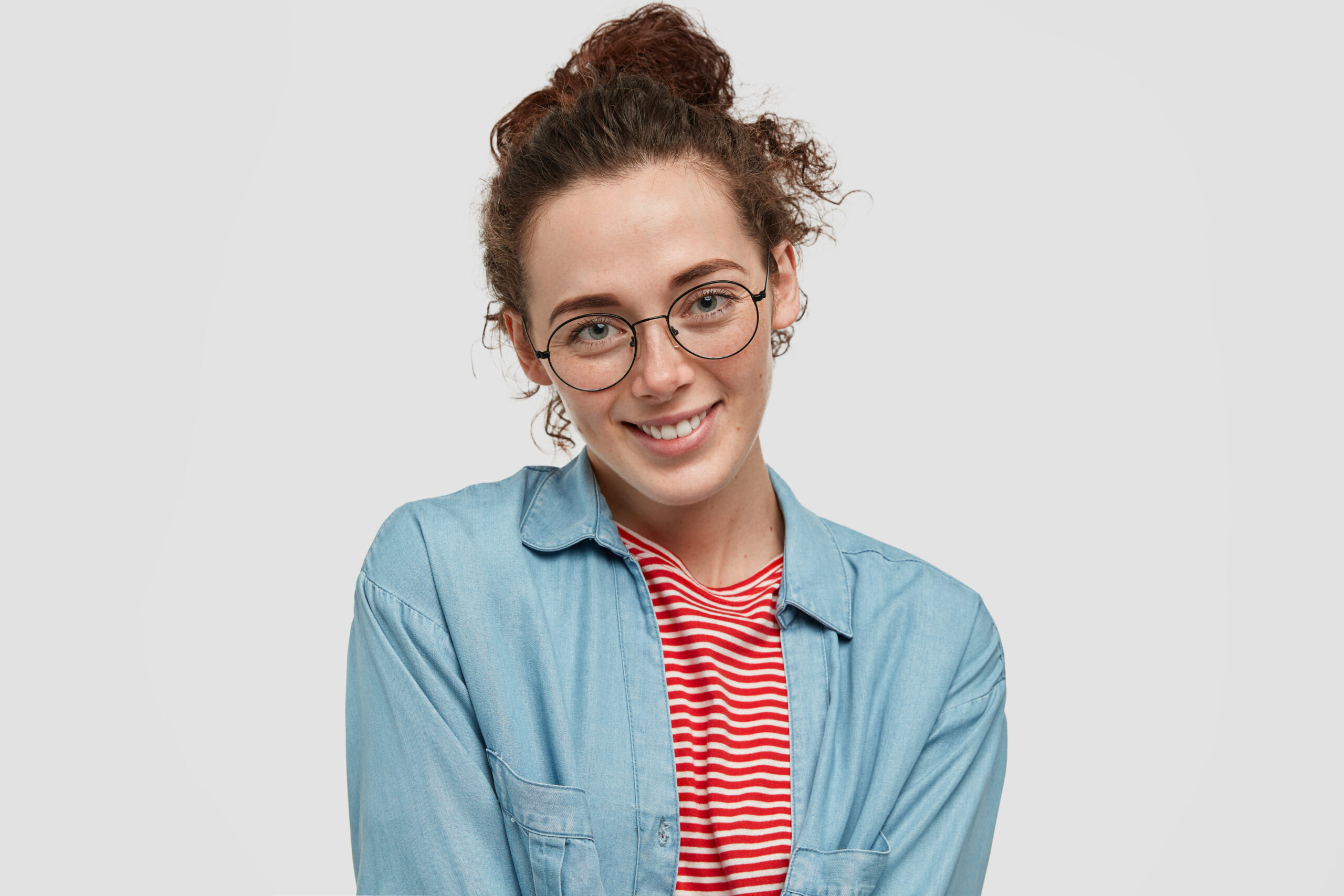 A woman smiling warmly, ready to answer important questions about landscaping services.