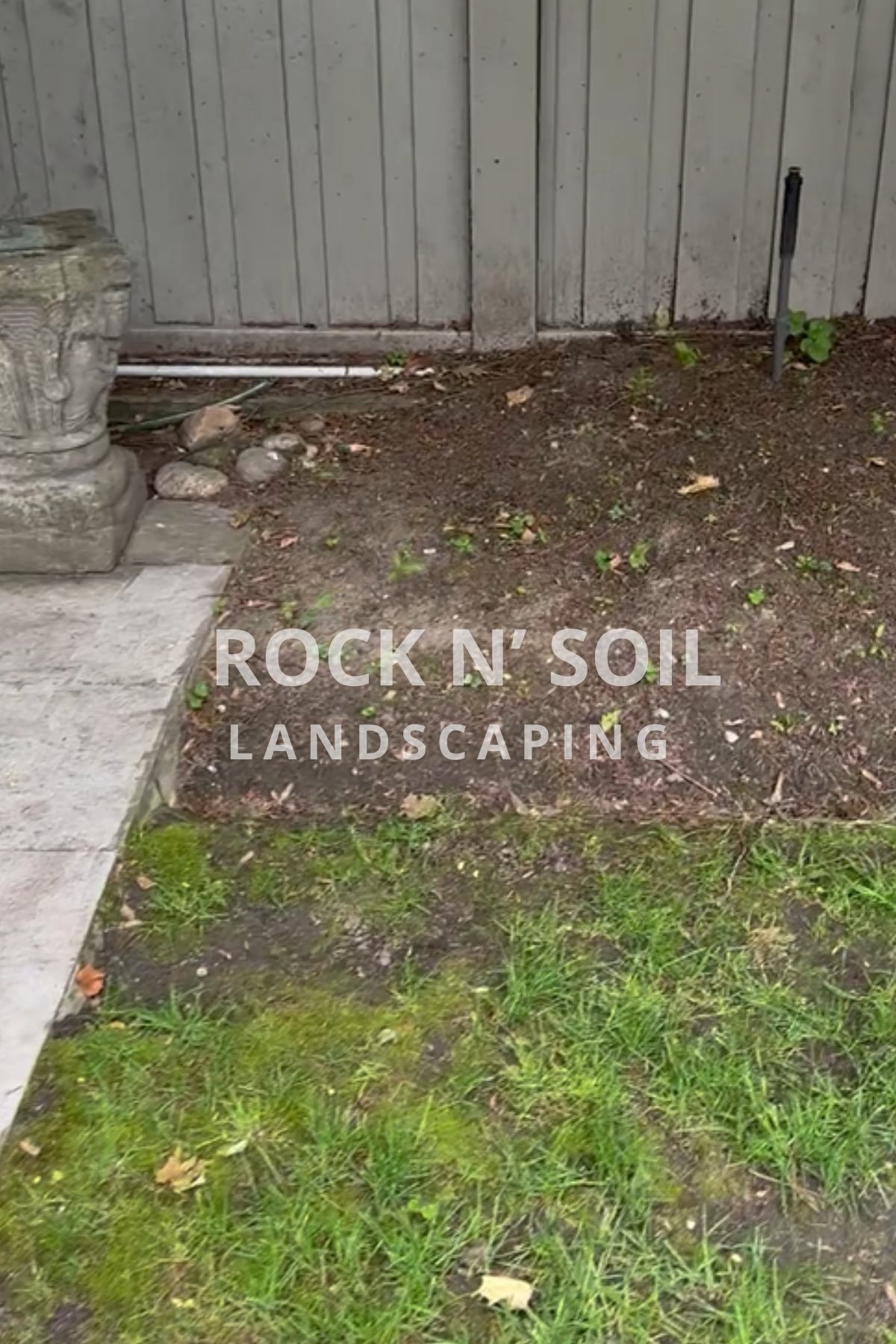 this is a before and after photo, this is a before photo of the backyard where is looks dull and boring