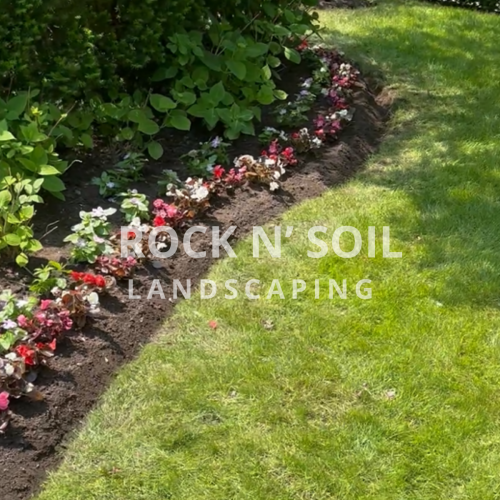 this is a before and after photo, this is a after photo of the backyard where is looks colorful and well maintained