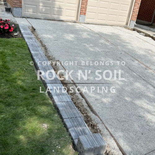 Driveway before interlocking, showing the original state before landscaping work